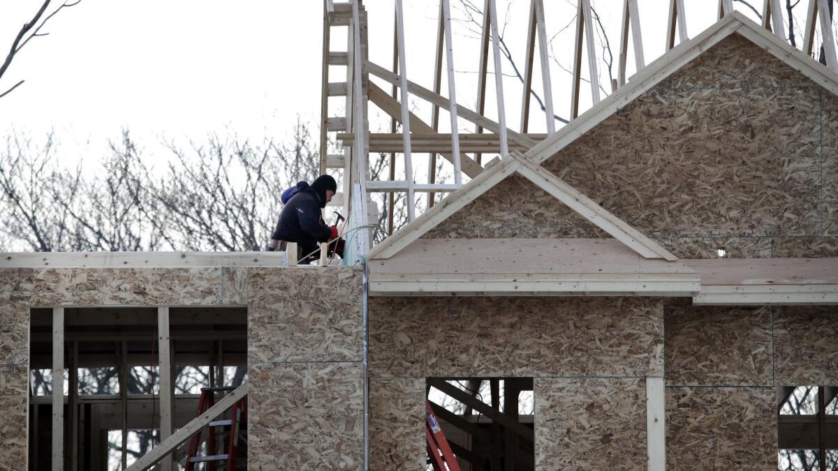 Construction workers build housing in Salisbury, Mass. on Jan. 23.