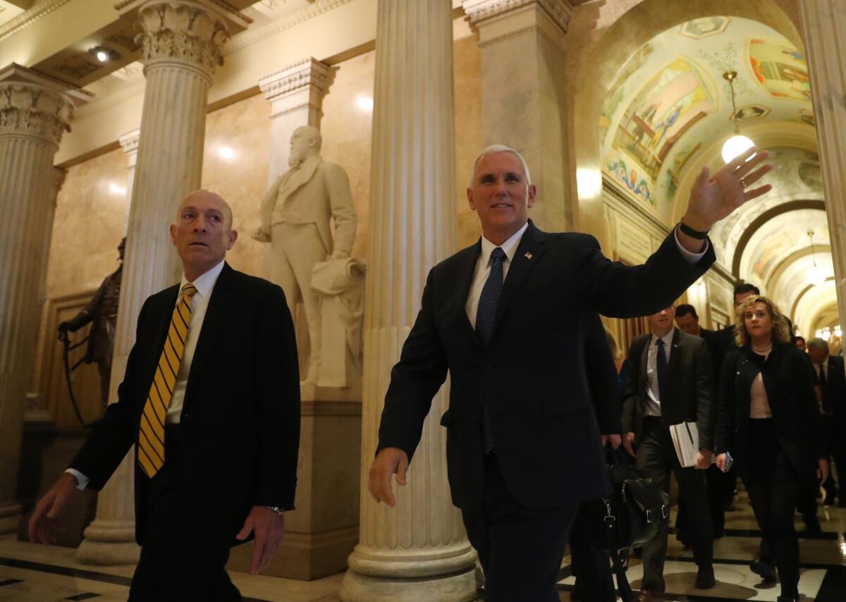 Vice President-elect Mike Pence waves as he arrives Thursday to meet with Capitol Hill leadership.