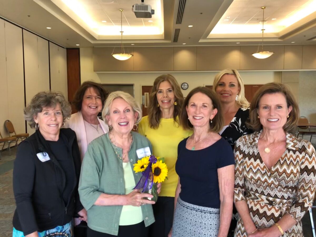 In early March, community members helped surprise San Dieguito Alliance with the award announcement: First row, left to right, Nancy Perry Sheridan, Judi Strang, Katie Poponyak, and Terri Ann Skelly. Second row, left to right, Janet Asaro, Kelly McCormick, and Becky Rapp.