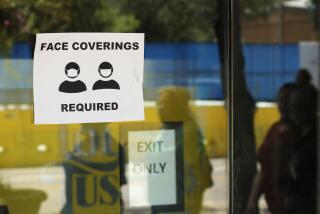 People wearing masks to protect against the spread of COVID-19 are reflected next to a sign requiring face coverings at a business in San Antonio, Wednesday, June 24, 2020, in San Antonio. Cases of COVID-19 have spiked in Texas and the governor of Texas is encouraging people to wear masks in public and stay home if possible. (AP Photo/Eric Gay)