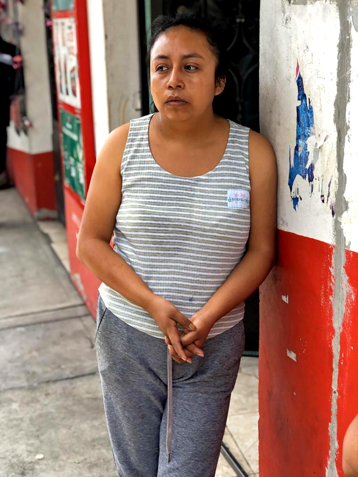 Saida Rojas, 26, daughter of Jose Felix Rosas, outside their home in La Magdalena Axocopan