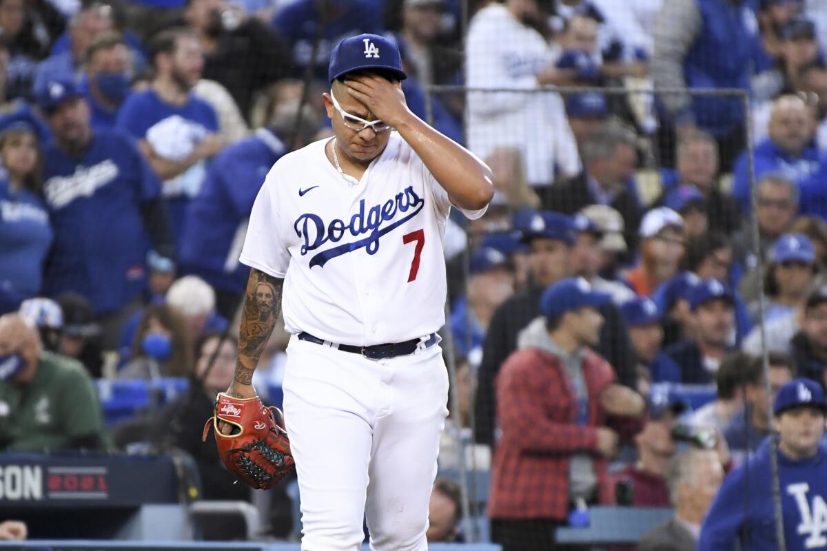 Dodgers starting pitcher Julio Urías reacts after allowing a triple to Atlanta's Eddie Rosario during the third inning.
