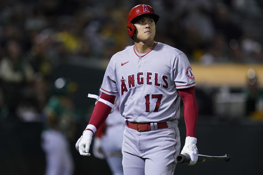 Los Angeles Angels' Shohei Ohtani walks to the dugout after striking out