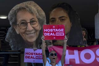 Relatives and supporters of Israeli hostages held by Hamas in Gaza hold photos of their loved ones during a protest calling for their return in Tel Aviv, Israel, Thursday, Aug. 15, 2024. (AP Photo/Ariel Schalit)