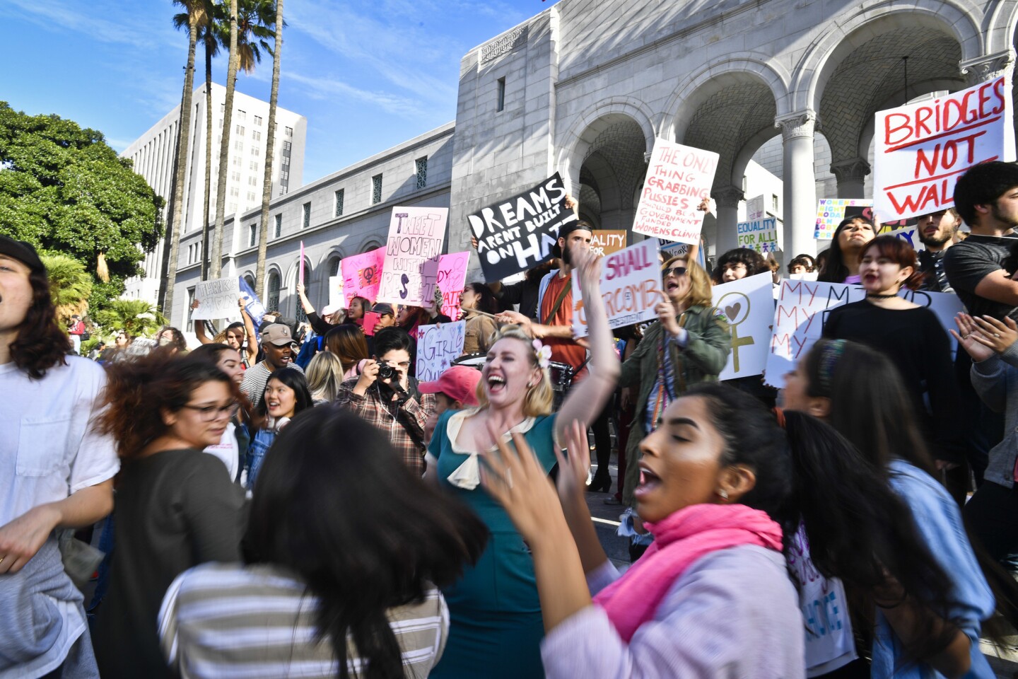 Demonstrators line the steps of City Hall while chanting slogans and dancing after the women's march in downtown Los Angeles.