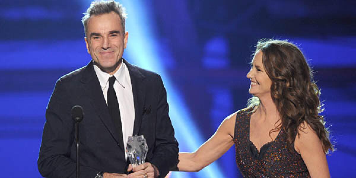 Presenter Melissa Leo (R) looks on as actor Daniel Day-Lewis accepts the Best Actor Award for "Lincoln."