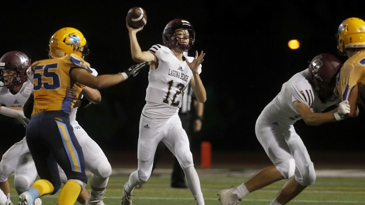 Laguna Beach High quarterback Andrew Johnson (12) throws against Marina during the first half of a nonleague game at Westminster High on Sept. 28.