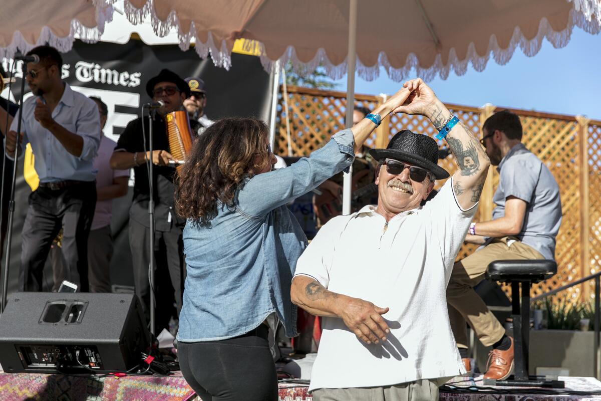 Michael Sanchez dances with a new friend while Boogaloo Assassins plays.