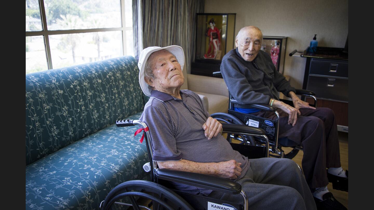 The Kawano brothers -- Yosh, 94, left, and Nobe, 93 -- were longtime clubhouse managers for the Cubs and Dodgers, respectively, and now live in the same retirement home in Los Angeles. Yosh wears one of the signature hats he wore in the clubhouse.