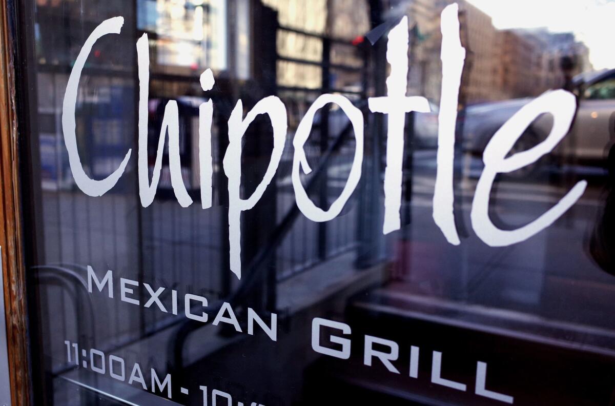 The Chipotle logo is seen on the door of one of its restaurants on January 2015 in Washington, D.C. The chain will close all of its stores for part of the day on Feb. 8 for a national meeting.