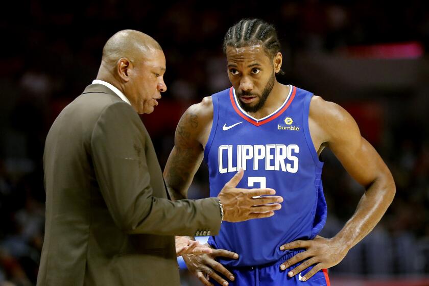 LOS ANGELES, CALIF. - NOV. 24, 2019. Clippers coach Doc Rivers talks with forward Kawhi Leonard.