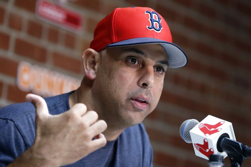 FILE— In this Sept. 9, 2019, file photo, Boston Red Sox manager Alex Cora talks about the dismissal of president of baseball operations Dave Dombrowski, during a news conference before the team's baseball game against the New York Yankees in Boston. Cora was fired by the Red Sox on Tuesday, Jan. 14, 2020, a day after baseball Commissioner Rob Manfred implicated him in the sport's sign-stealing scandal. (AP Photo/Michael Dwyer, File)