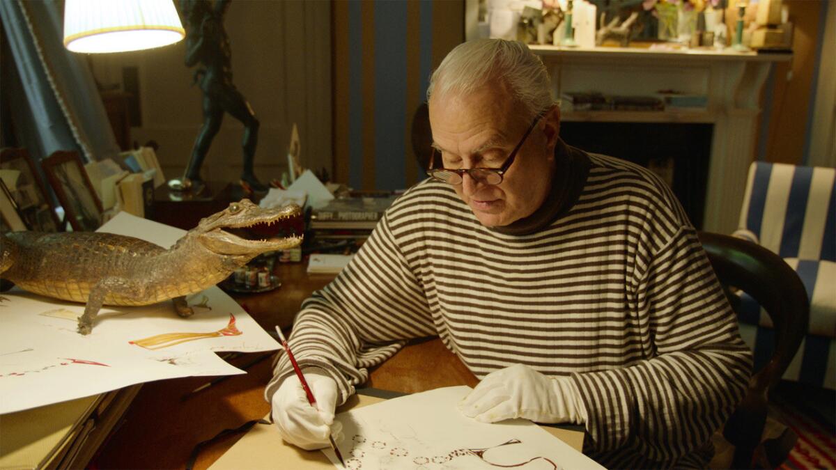 Manolo Blahnik shown sketching one of his artful creations, as seen in the new film about his life. (Music Box Films)