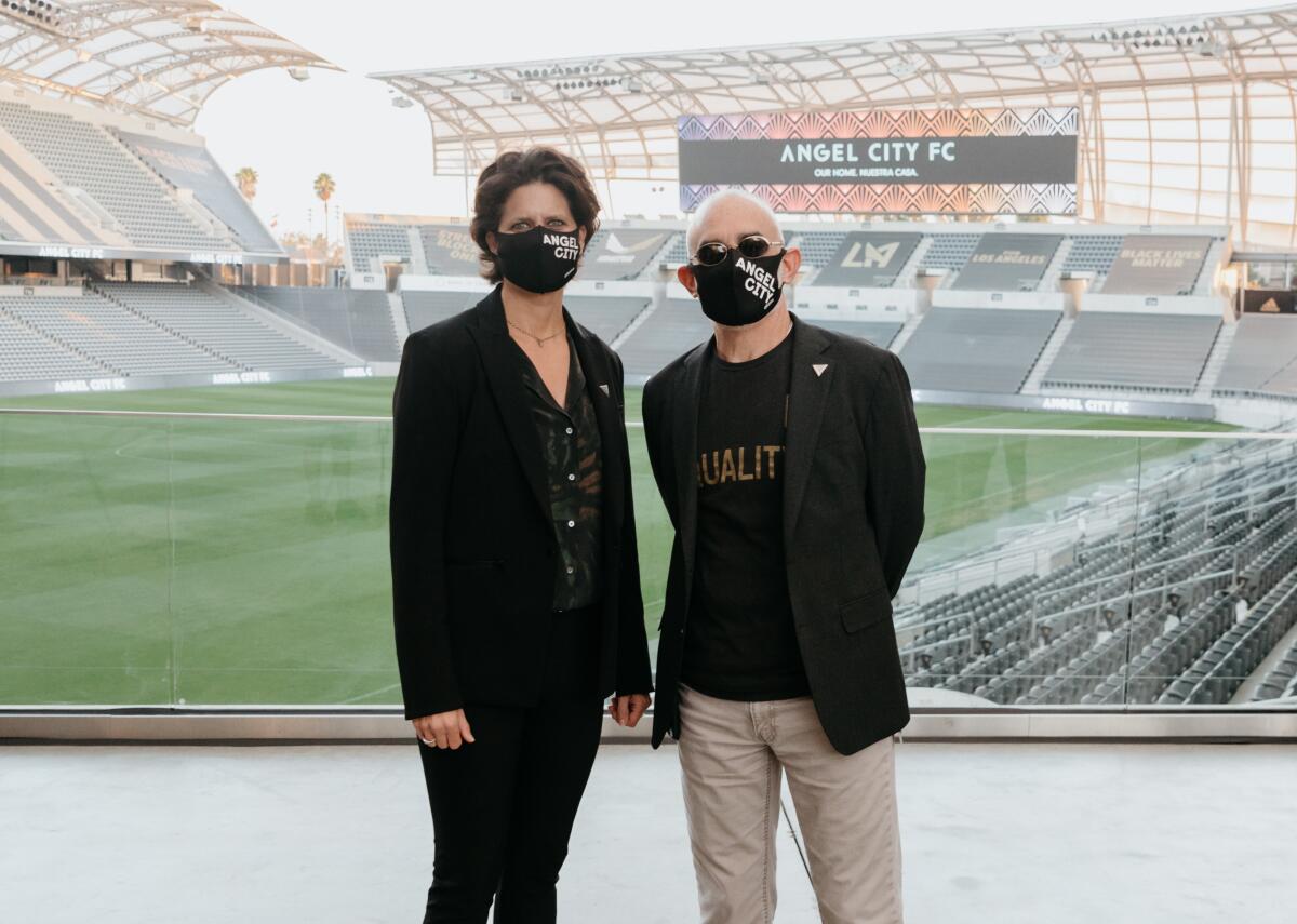 Angel City president Julie Uhrman, left, and LAFC co-owner Larry Freedman stand together.