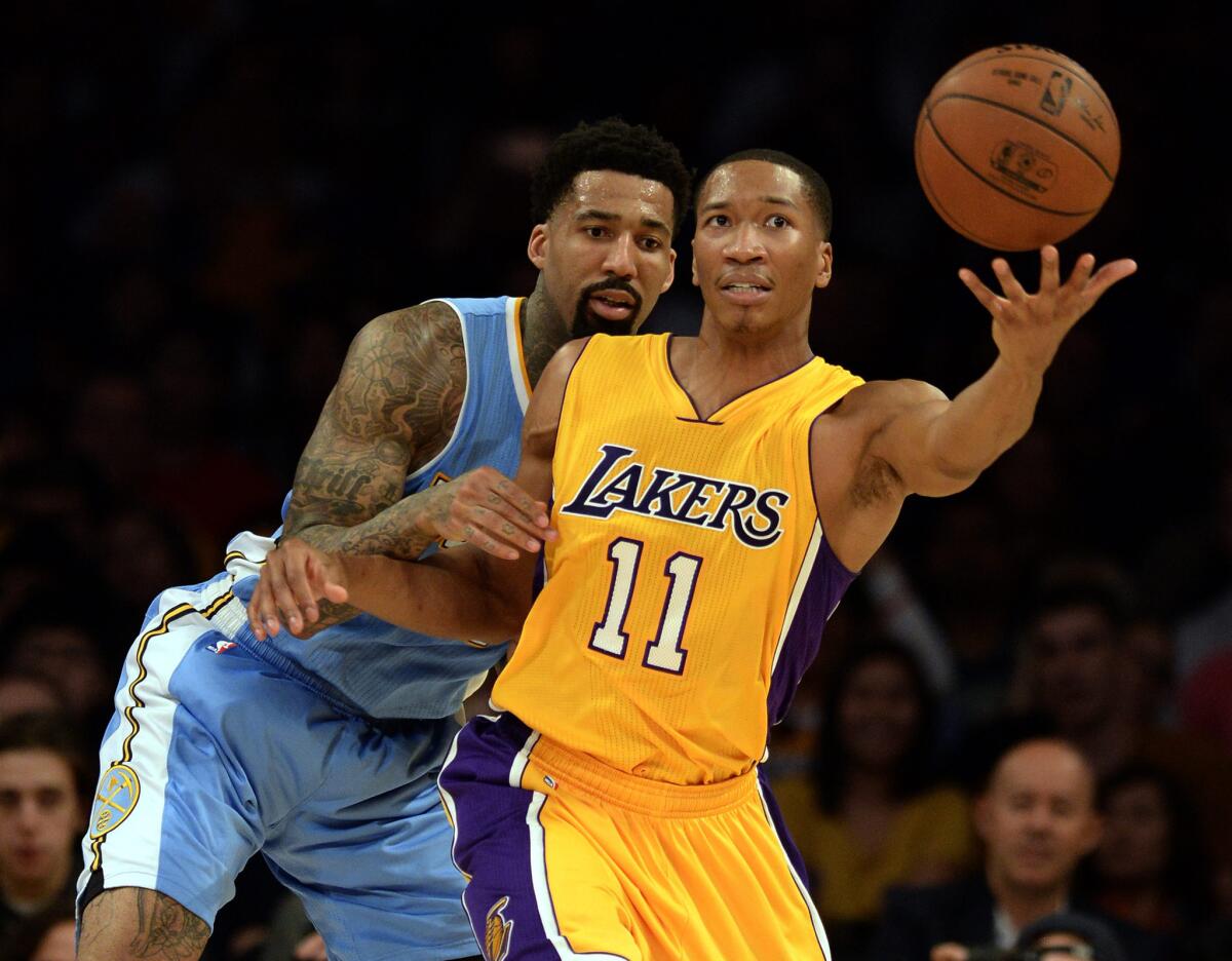 Wesley Johnson is guarded by Denver's Wilson Chandler during the first half of a game Tuesday at Staples Center.