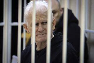 FILE - Ales Bialiatski, the head of Belarusian Vyasna rights group, sits in a defendant's cage during a court session in Minsk, Belarus, on Jan. 5, 2023. The wife of Bialiatskian, an imprisoned Belarusian Nobel Peace Prize laureate, said Wednesday July 10, 2024 that the country's authorities are depriving her husband of medicine as his health deteriorates. (Vitaly Pivovarchyk/BelTA Pool Photo via AP, File)