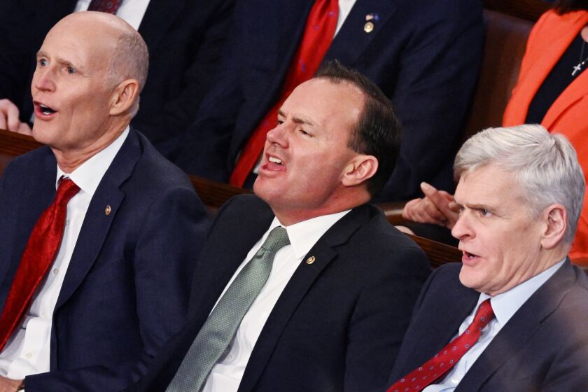 (L-R) US Senators Rick Scott (R-FL), Mike Lee (R-UT) and Bill Cassidy (R-LA) yell as US President Joe Biden delivers the State of the Union address at the US Capitol in Washington, DC, February 7, 2023. (Photo by ANDREW CABALLERO-REYNOLDS / AFP) (Photo by ANDREW CABALLERO-REYNOLDS/AFP via Getty Images)