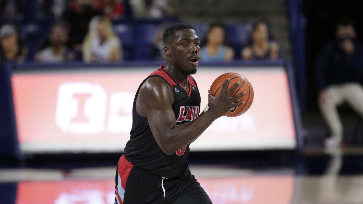 Loyola Marymount guard Eli Scott handles the ball.