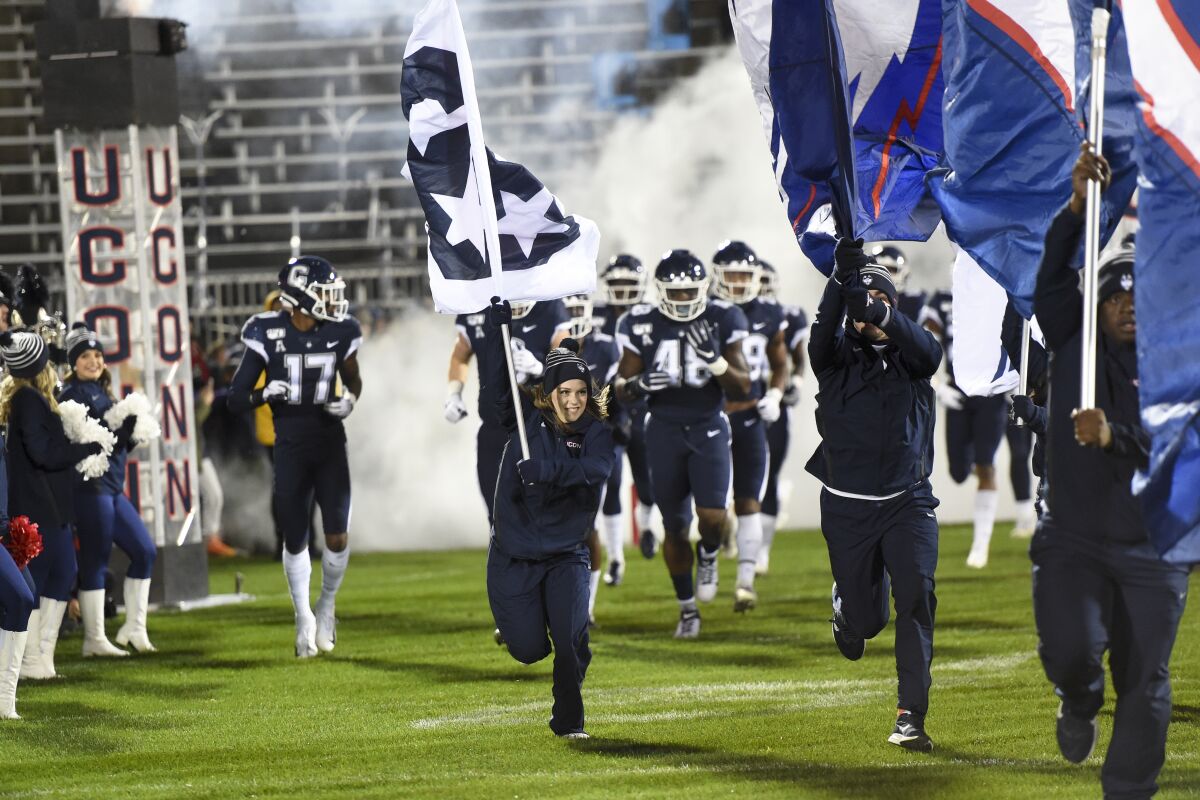 Connecticut takes the field before the start of a game against Navy on Nov. 1 in East Hartford, Conn.