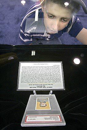 James Powel, age 11, from Van Nuys stares at a $1.3 million 1909 Honus Wagner baseball card locked in a glass display case.