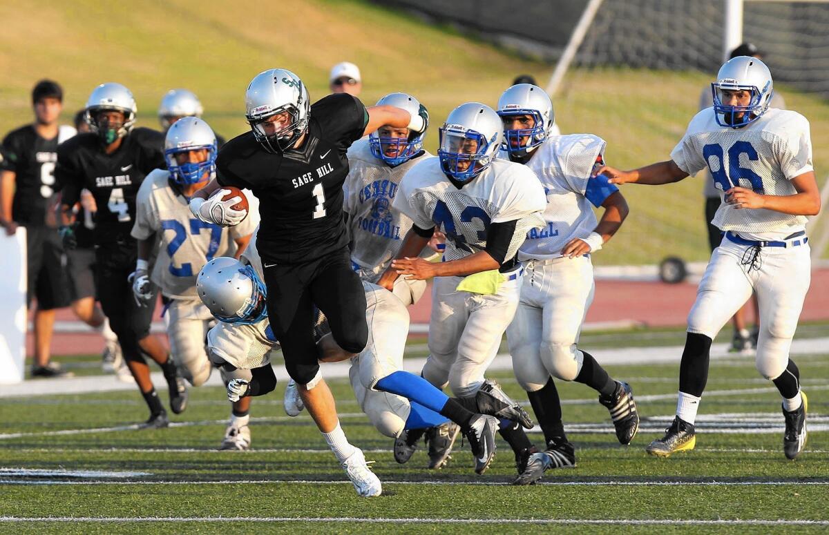 Sage Hill School's Jacob Copeland (1) is chased by a pack of Century defenders for a big gain in the first half of a scrimmage at Sage Hill on Friday.