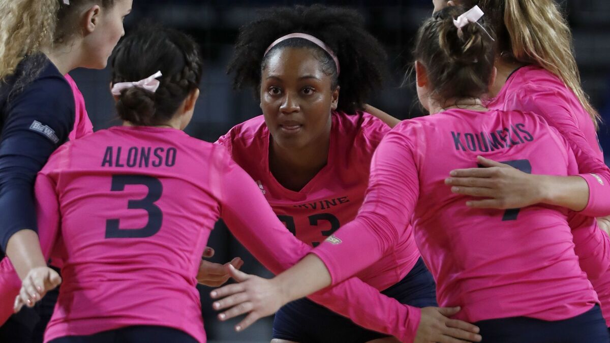 Idara Akpakpa huddles with teammates during a game against Cal State Fullerton at UCI's Bren Events Center.