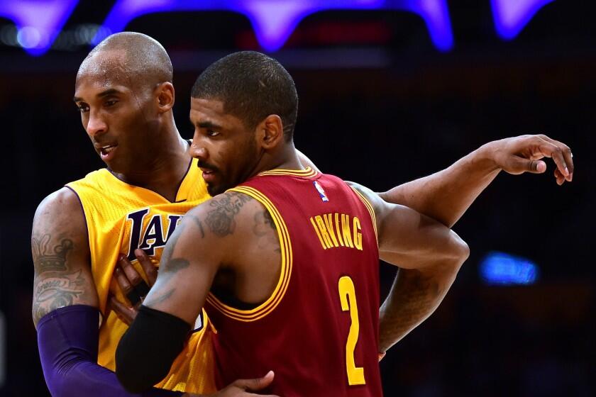 Lakers forward Kobe Bryant (24) guards Cavaliers point guard Kyrie Irving (2).