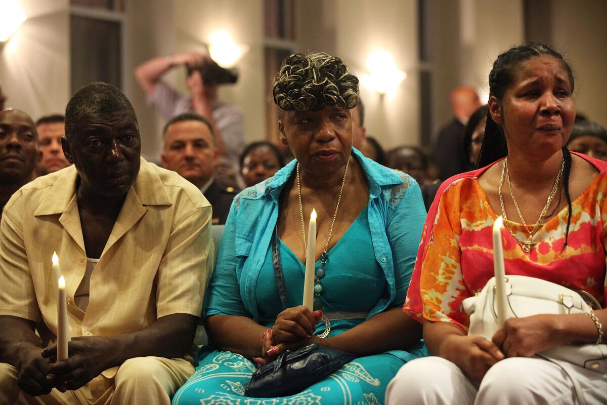 Eric Garner's family, from left, stepfather Benjamin Carr, mother Gwen Carr and widow Esaw Garner, attend an interfaith prayer service at Mount Sinai United Christian Church to mark the one-year anniversary of the death of Garner on July 14, 2015, in New York City.