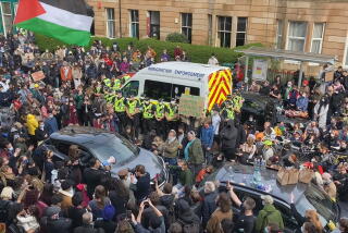 Protesters swarm a paddy wagon.