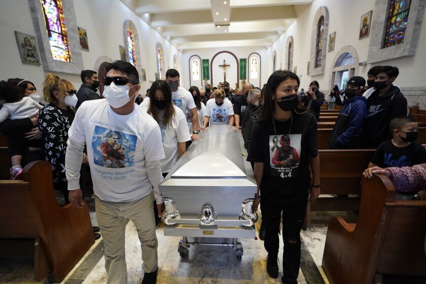 Coverage of Tijuana photojournalist Margarito Martinez Esquivel's funeral. The family of Margarito walks the casket out of the Santuario de Nuestra Senora del Sagrado Corazon on Friday, Jan. 21, 2022 in Tijuana, Baja California.