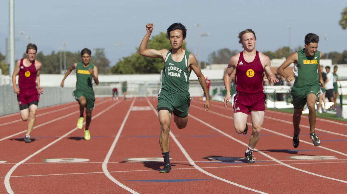 Costa Mesa High's Sonny Tran-Nguyen places 1st in a boys' 100-meter race during a track meet against Estancia and Saddleback on Thursday in Costa Mesa.