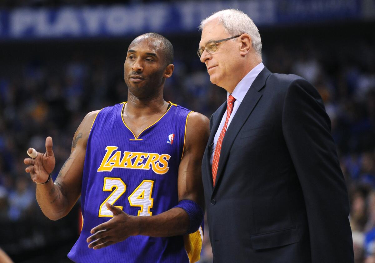 Lakers star Kobe Bryant speaks with coach Phil Jackson during Game 4 of the 2011 Western Conference semifinals.