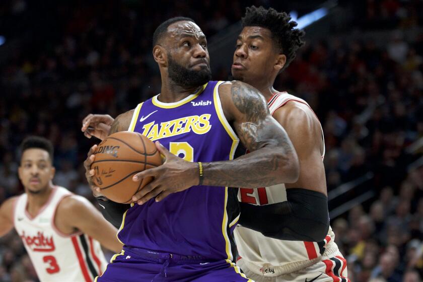 The Lakers' LeBron James battles the Trail Blazers' Hassan Whiteside on Dec. 28, 2019.
