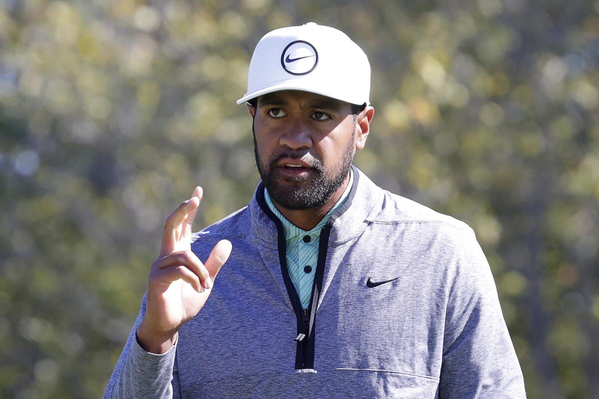 Tony Finau waves to the gallery as they cheer his birdie on the ninth hole during the final round of the Houston Open golf tournament Sunday, Nov. 13, 2022, in Houston. (AP Photo/Michael Wyke)