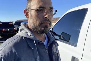 This photo posted on the Custer County Sheriff's Office Facebook page shows Hanme K. Clark as he's taken into custody by personnel from the New Mexico State Police and the U.S. Marshals Service, near Albuquerque, N.M., Tuesday, Nov. 21, 2023. Clark was captured after 25 hours on the run after police say he fatally shot three people and critically wounded a fourth in his latest property dispute with neighbors in rural Colorado, authorities said. (Courtesy of Custer County Sheriff's Office via AP)