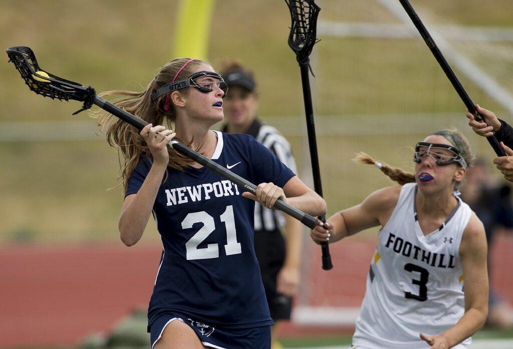 Newport Harbor's Heather Roberts looks for an open pass against Foothill's defender Allison Parkill during the semifinals of the U.S. Lacrosse Southern Section South Division playoffs on Saturday.