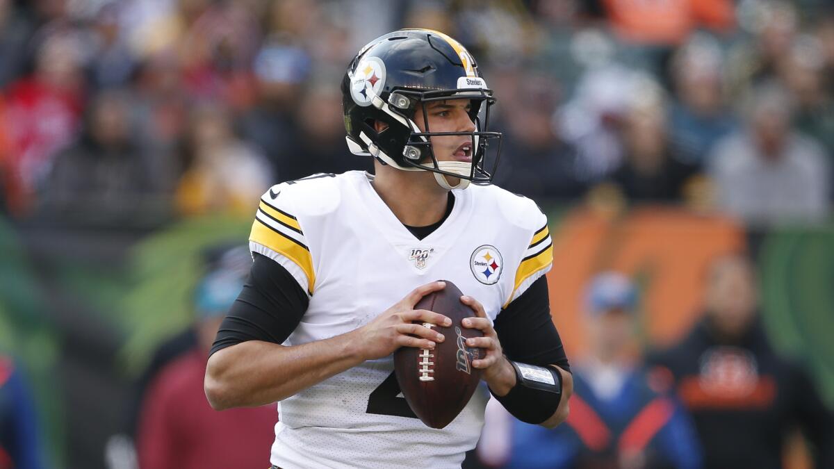 Pittsburgh Steelers quarterback Mason Rudolph looks downfield for somewhere to pass.