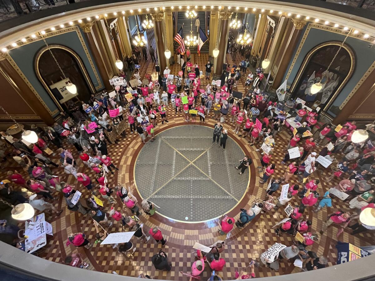 Protesters gather at the Iowa Capitol rotunda in opposition to a new ban on abortion after roughly six weeks of pregnancy.