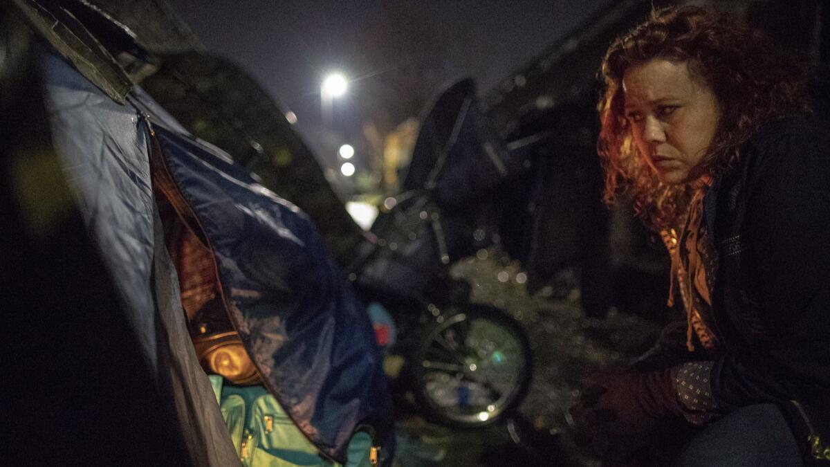 Montavilla Initiative chairwoman Todd talks with homeless man Kevin Heard outside his tent alongside a Portland MAX light rail line while on patrol in the Montavilla neighborhood in Portland, Ore.