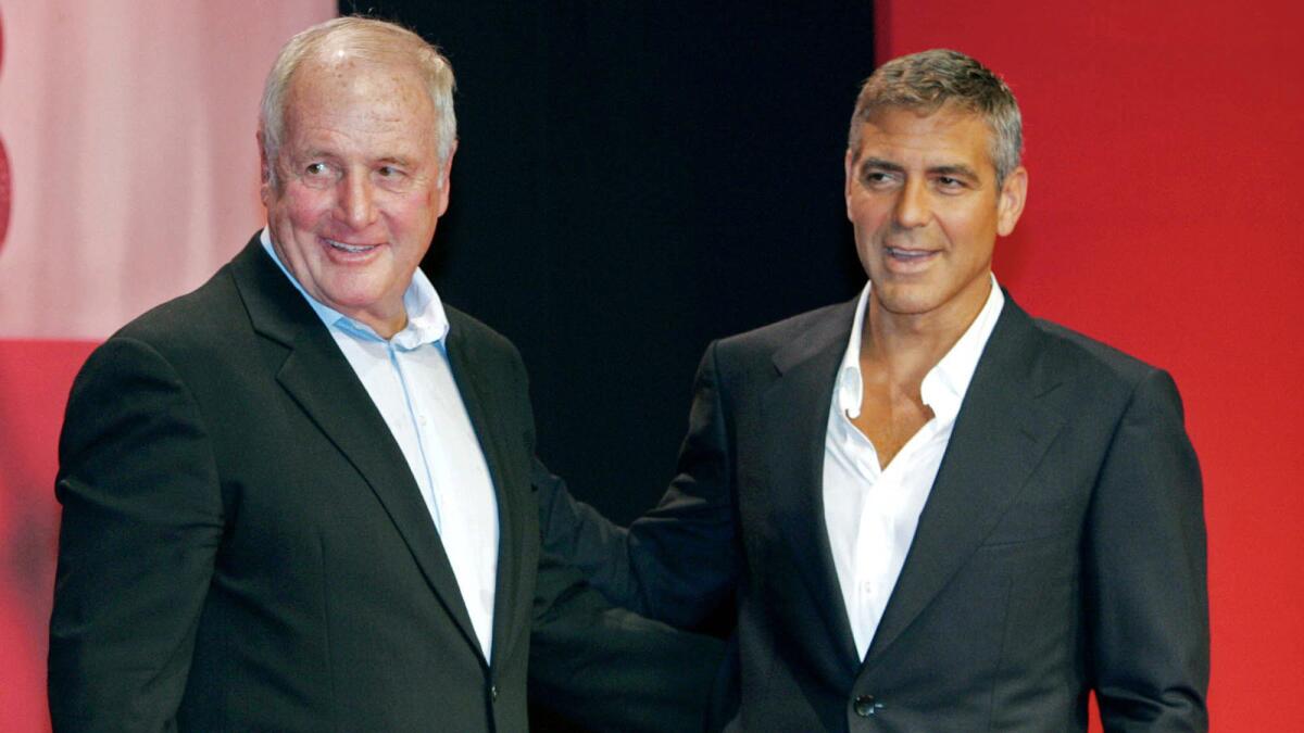 Jerry Weintraub, left, poses with actor George Clooney during a press conference in Tokyo to promote the film "Ocean's Thirteen."