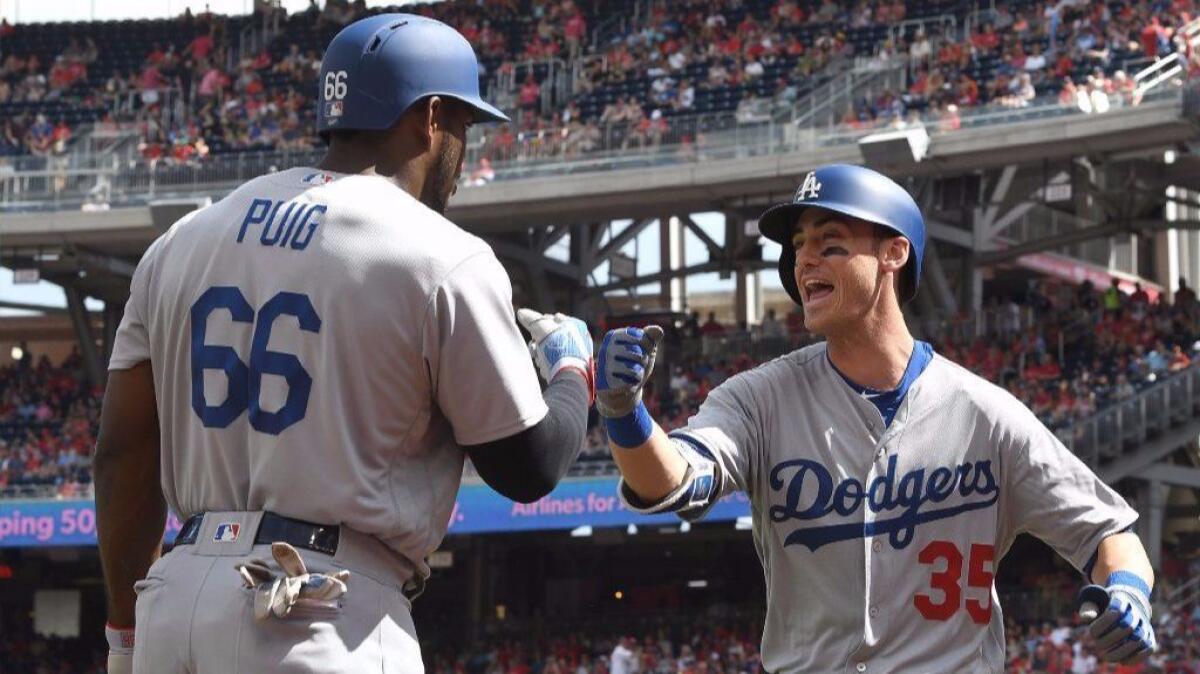Cody Bellinger celebrates with Yasiel Puig after hitting a home run in the second inning against the Washington Nationals at Nationals Park on Sept. 16.