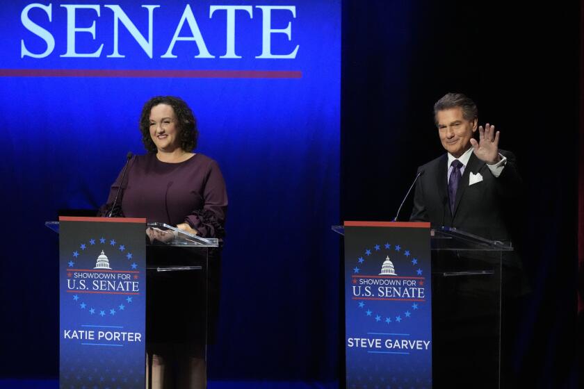U.S. Rep. Katie Porter, D-Calif., left, and former baseball player Steve Garvey react during a televised debate for candidates in the senate race to succeed the late California Sen. Dianne Feinstein, Monday, Jan. 22, 2024, in Los Angeles. (AP Photo/Damian Dovarganes)