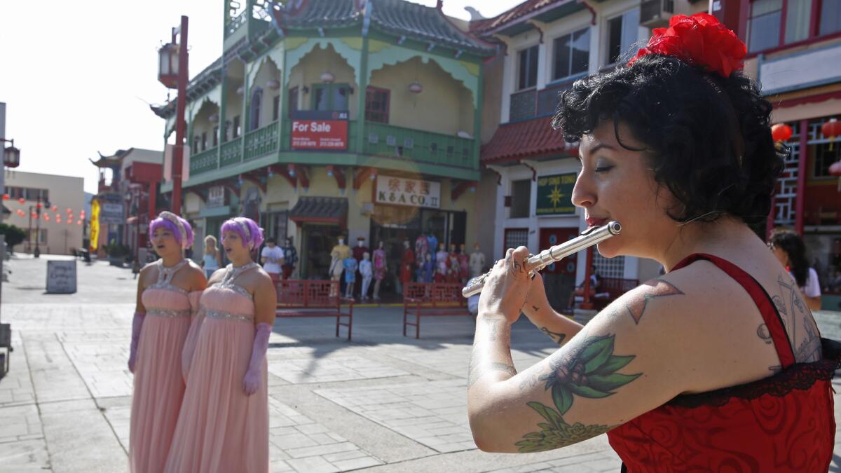 Christine Tavolacci plays flute in Chinatown during a rehearsal for "Hopscotch."