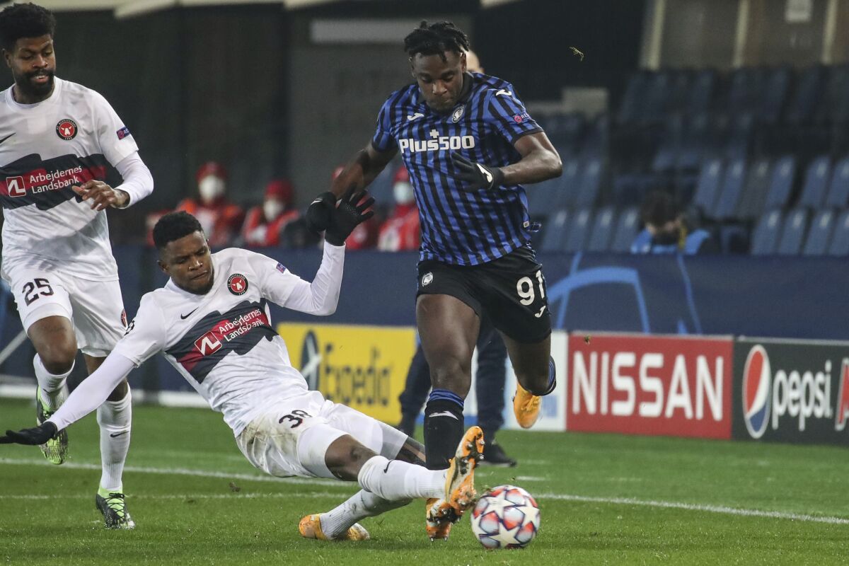 Midtjylland's Frank Onyeka (38) competes for the ball against Atalanta's Duvan Zapata during their Group D, Champions League soccer match between Atalanta and FC Midtjylland, at the Geweiss stadium in Bergamo, Italy, Tuesday, Dec. 1, 2020. (Stefano Nicoli/LaPresse via AP)