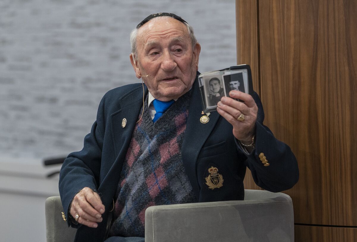 Joseph Alexander holds photos of his family.