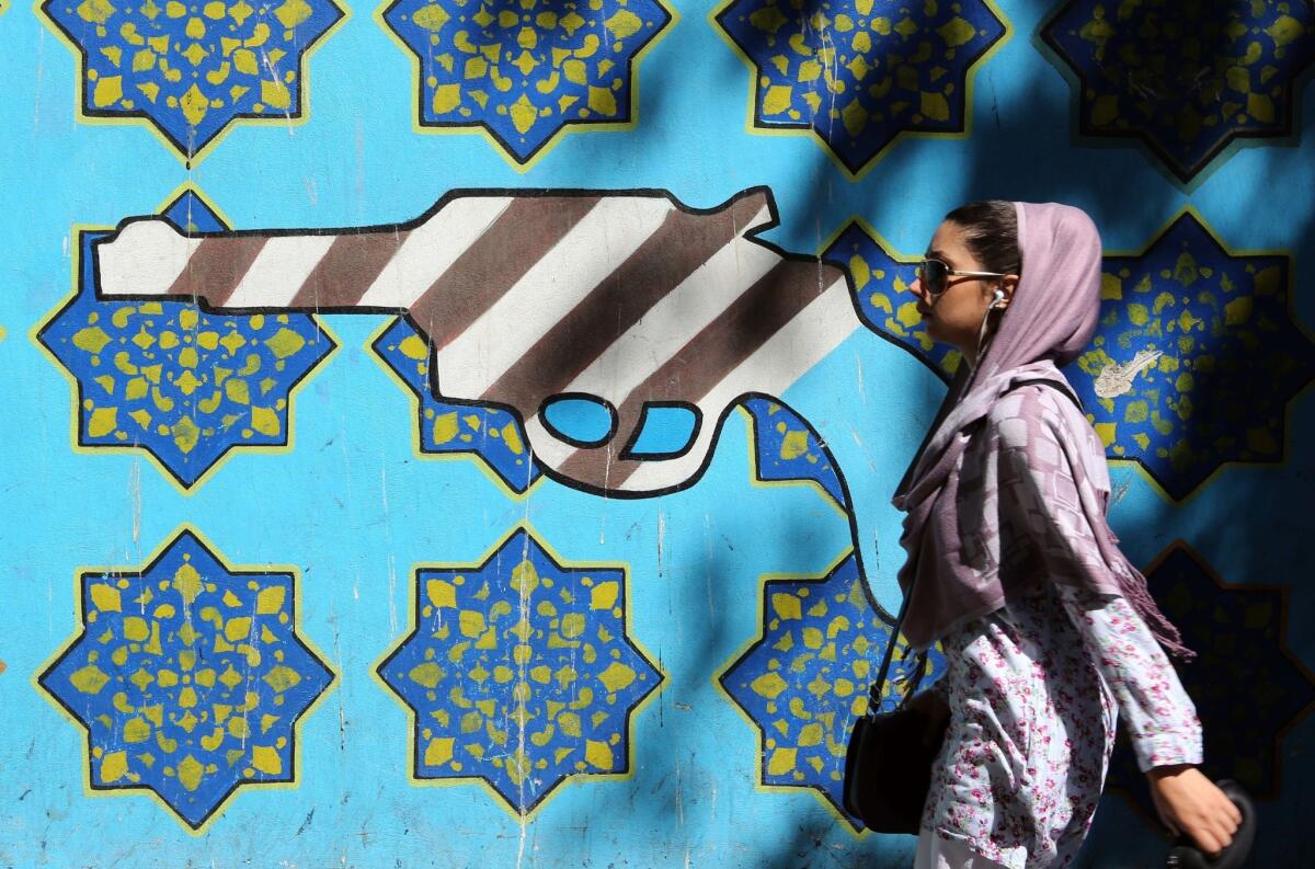 A mural shows a gun painted with an interpretation of the American flag on the wall of the former U.S. Embassy in Tehran in September.