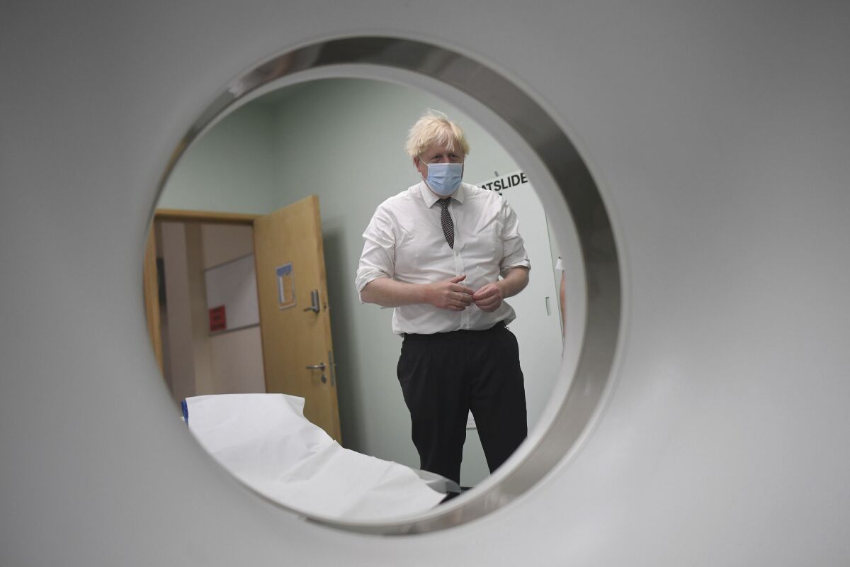 Britain's Prime Minister Boris Johnson is shown around a CT scan room during a visit to Hexham General Hospital in Northumberland, England, Monday, Nov. 8, 2021. (Peter Summers/Pool Photo via AP)