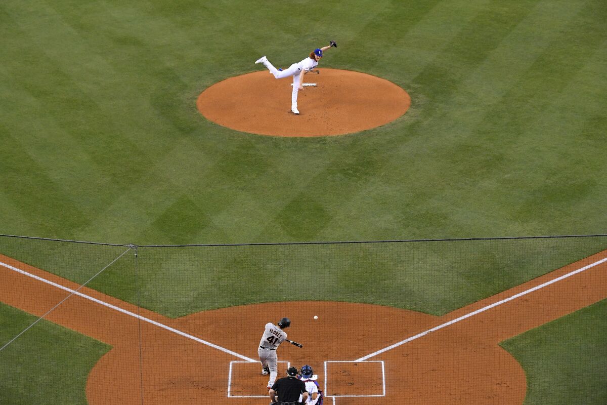 Dodgers starting pitcher Dustin May delivers to San Francisco's Wilmer Flores during the first inning.