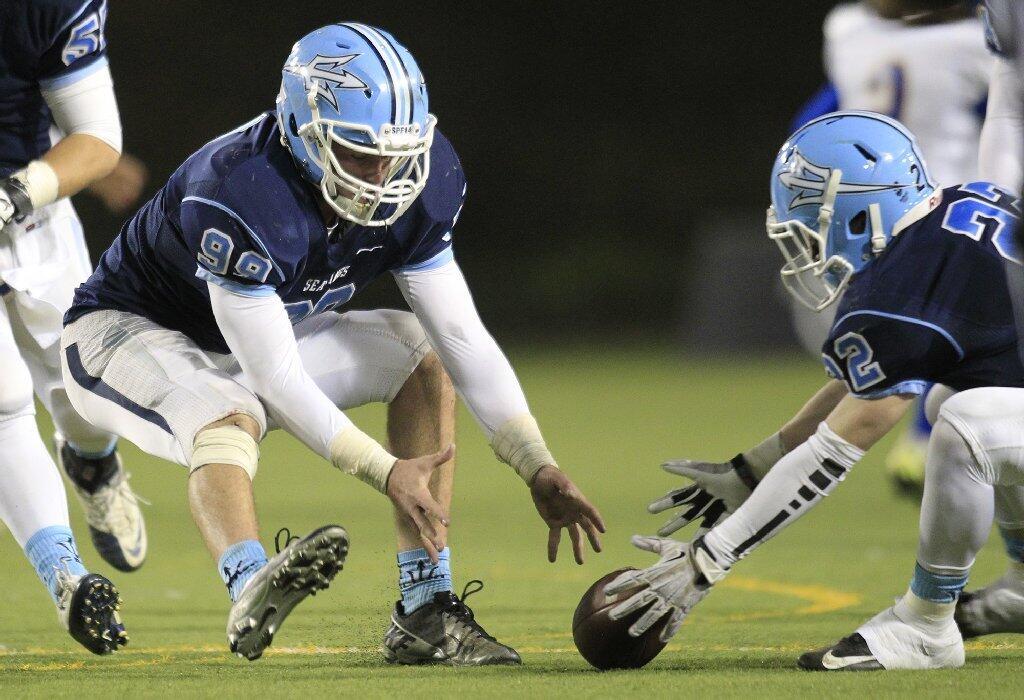 Corona del Mar High's Parker Chase, left, and teammate Hugh Crance go to recover a blocked punt during the first half against Nordhoff in the CIF State Southern California Regional Division III Bowl Game at LeBard Stadium in Costa Mesa on Saturday.