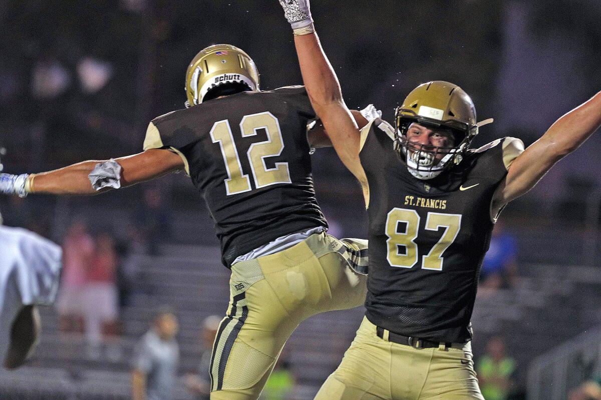 St. Francis' Evan Jernegan celebrates with teammateTanner Tomko after catching a long pass for a touchdown against Mira Costa in Friday's season-opening game.